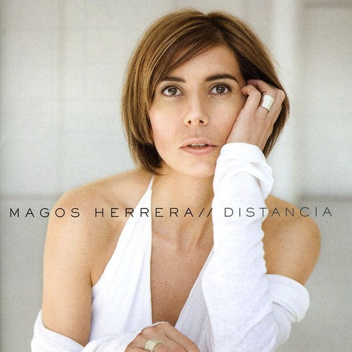 the album cover for Magos Herrera - Distancia