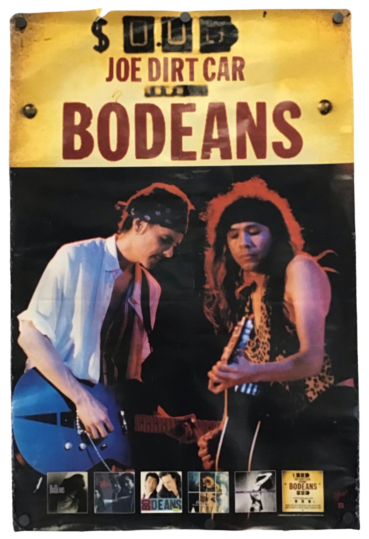 Vintage-style metal sign for Joe Dirt Car and Bodeans, featuring a yellow header with distressed text and a black-and-color photo of two men playing guitars, mounted against a white background.