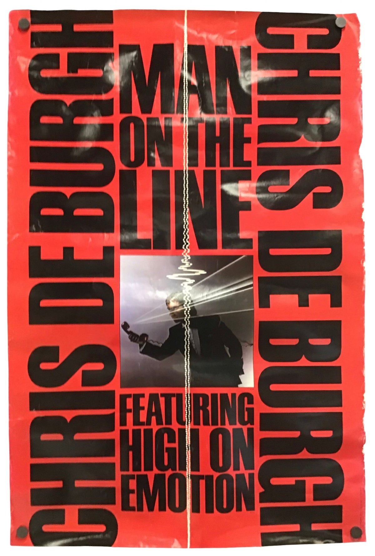 A red and black promotional poster for Chris DeBurgh's album 'Man on the Line', featuring bold black typography on a bright red background and a central inset photo of the artist performing.