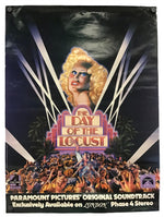 Vintage movie poster for 'The Day of the Locust' featuring a blonde woman's portrait, a large crowd at the bottom, and promotional text for a Paramount Pictures original soundtrack on London Phase 4 Stereo.