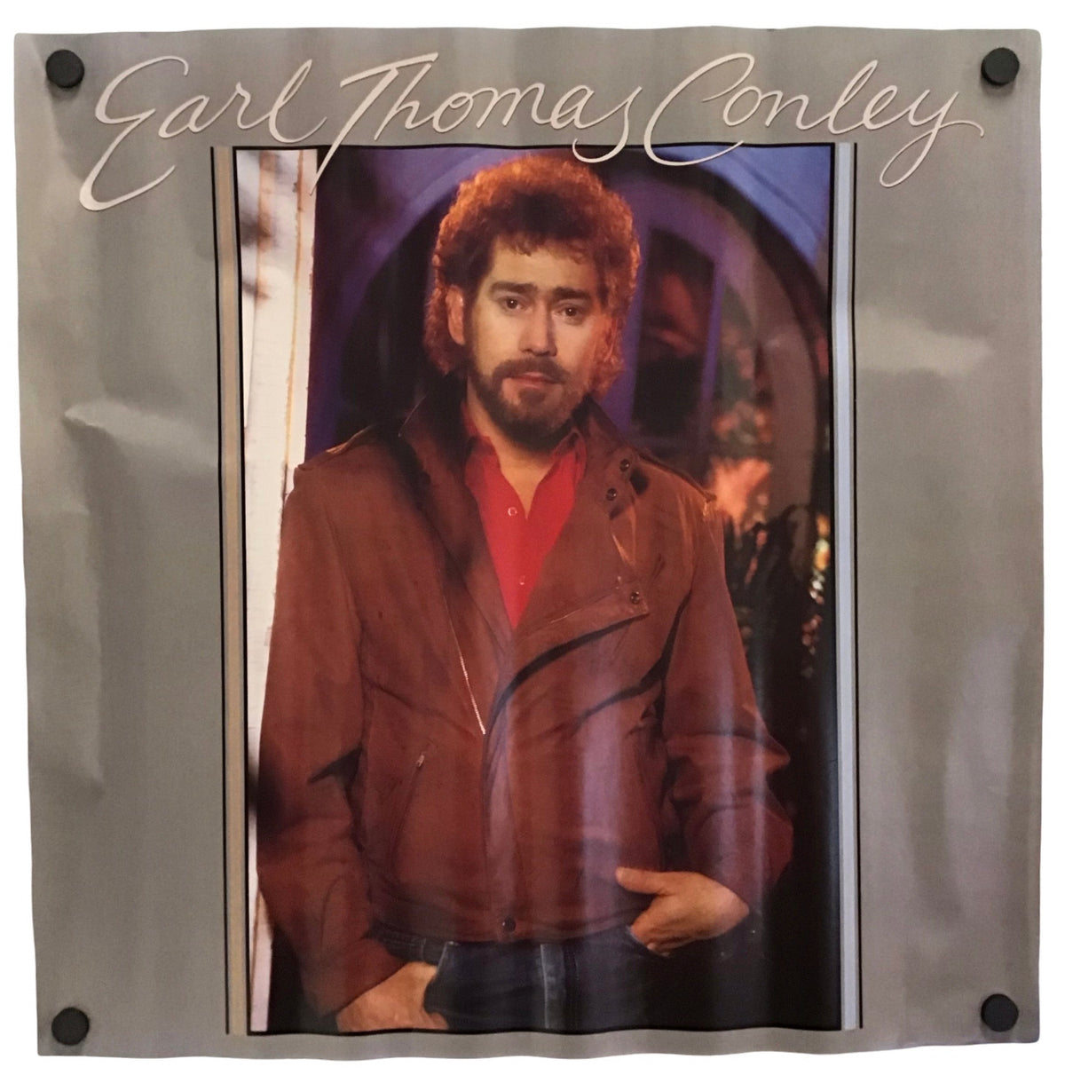 A vintage printed poster or album-style print featuring a portrait of Earl Thomas Conley, with his name in large script across the top and a gray border around the printed area.