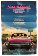 A vertical movie poster for the film 'Heartbreak Hotel' featuring a large scenic photograph of a pink convertible car on a highway at sunset, with the title in pink and white text at the top.