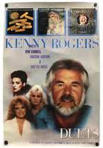 A vintage-style Kenny Rogers 'Duets' poster or print featuring portraits of Kenney Rogers, Kim Carnes, Sheena Easton, and Dottie West, with three album-cover style panels across the top and large blue title text reading 'KENNY ROGERS' and 'DUETS'.