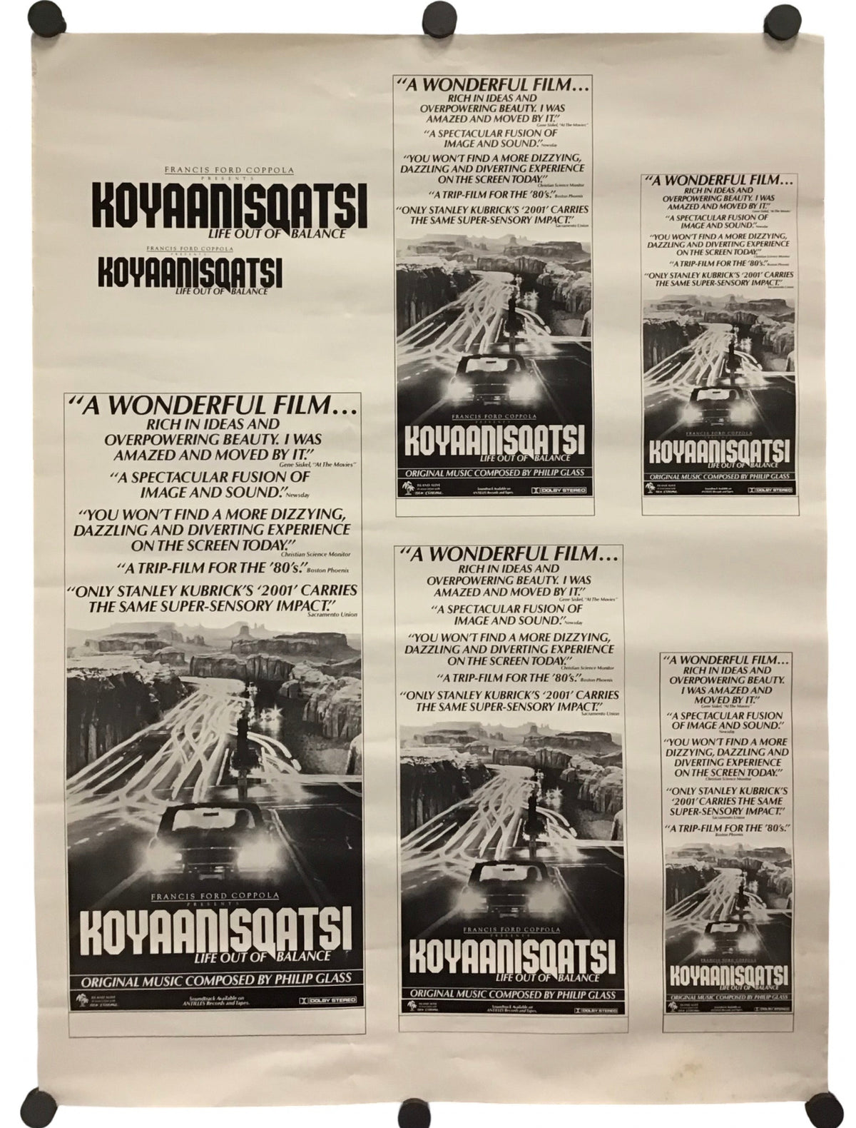 A vintage-style movie poster for the film 'Koyaanisqatsi' featuring multiple panels with black-and-white imagery, quotes, and title text on an off-white background, displayed against a white backdrop with black mounting clips at the corners.