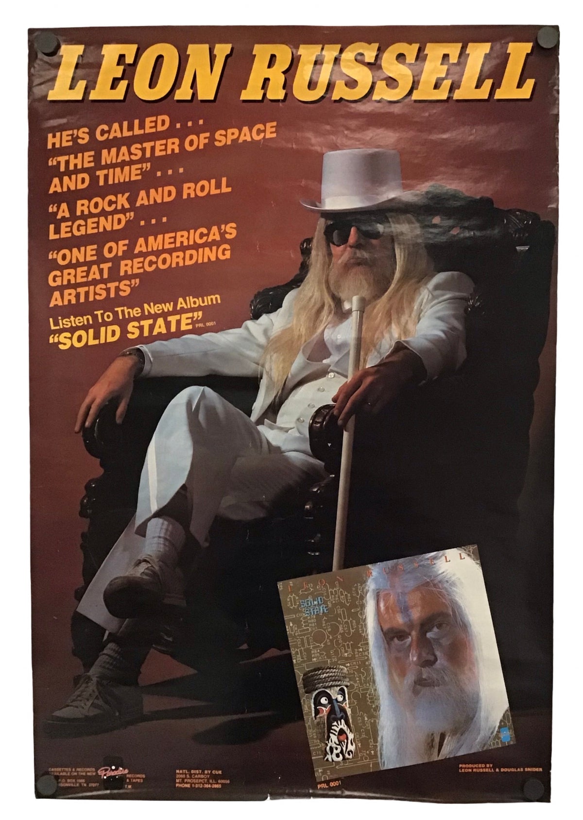 A vintage-style poster or print featuring Leon Russell, with large yellow text at the top, a seated figure in a white suit and hat, and a smaller inset portrait near the bottom, shown against a plain white background.