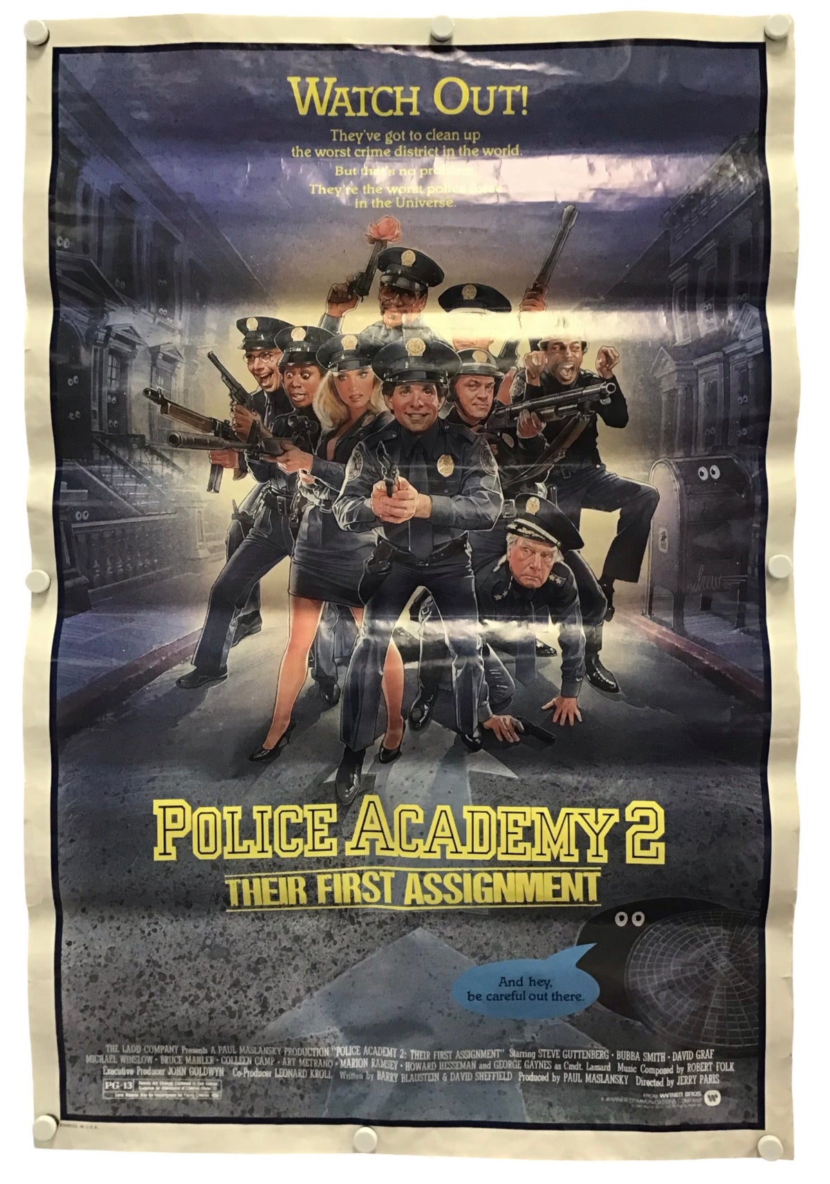 A vintage-style movie poster for 'Police Academy 2: Their First Assignment' displayed flat against a light background, secured with small pins at the corners.