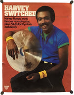 A vintage promotional poster for Sabian Cymbals featuring performer Harvey Mason, with the headline 'Harvey Switched' on a rust-orange background. The poster shows a seated man in a blue shirt holding a cymbal, and the Sabian logo appears at the bottom left.
