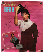 An autographed Scott Baio concert poster on a pink background, featuring a photo of Scott Baio tipping his hat, a small inset photo, a cassette graphic, and his signature.