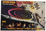 A vintage concert poster for the band Spyro Gyra's 'Access All Areas' 2nd Reckord Set, featuring a colorful spiral graphic, a live band performance, and song titles at the bottom, displayed against a plain white background.