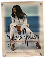 A vintage-style music poster for Suleika Johnson's album 'Chapter 1: Love, Pain & Forgiveness' displayed on a white background with binder clips at the corners. The poster features a seated woman in a white outfit against a blue and gray background, with the artist's name in large black script and red subtitle text.