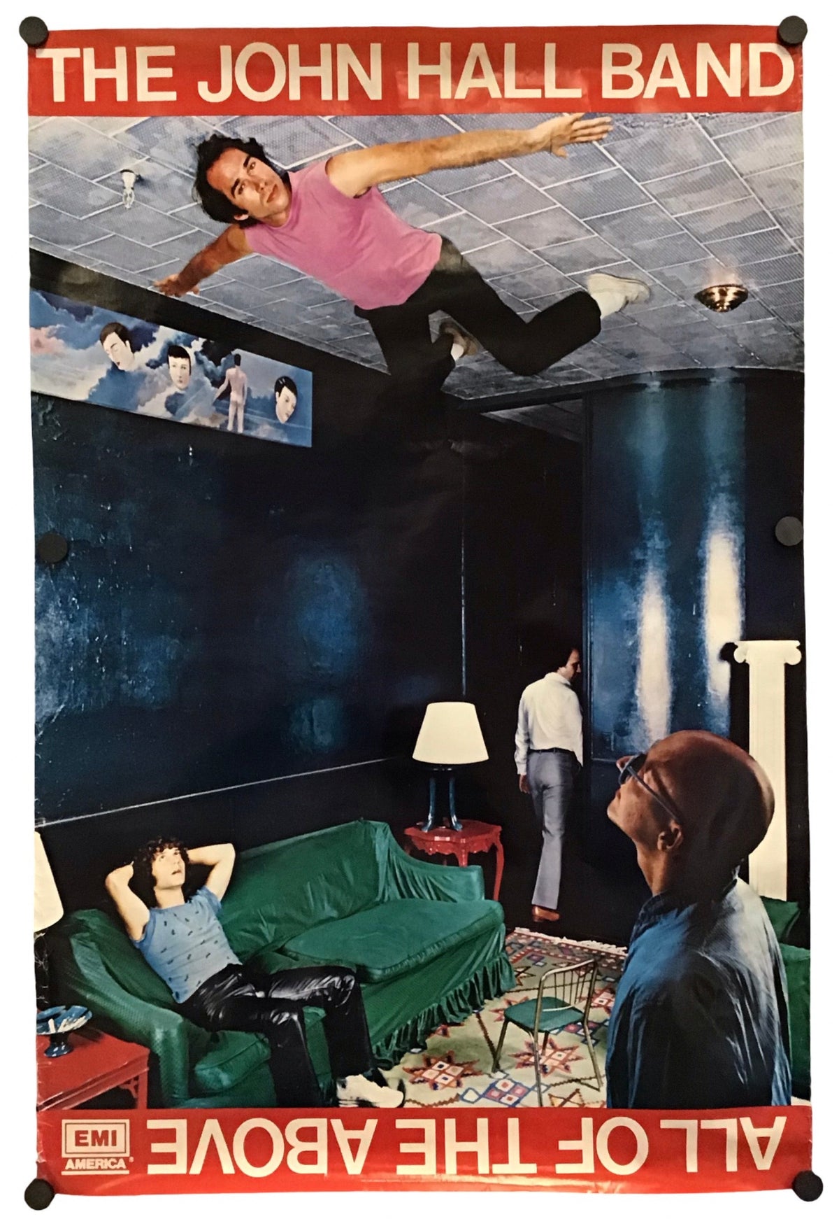 A vintage-style band poster for 'The John Hall Band' featuring a surreal collage scene with a man floating in a ceiling, a green sofa, and red title bands at the top and bottom, shown hanging against a white background.