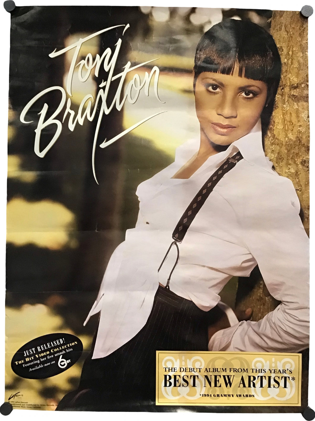 A vintage-style Tony Bratton album cover or poster featuring a portrait of Tony Bratton in a white shirt leaning against a tree, with large white script text reading 'Tony Bratton' and a gold-toned 'Best New Artist' badge at the bottom.