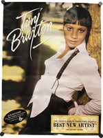 A vintage-style Tony Bratton album cover or poster featuring a portrait of Tony Bratton in a white shirt leaning against a tree, with large white script text reading 'Tony Bratton' and a gold-toned 'Best New Artist' badge at the bottom.