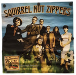 A vintage-style poster or print for 'Squirrel Nut Zippers' featuring a group of illustrated characters under the title text, displayed against a plain white background with binder clips attached at the corners.