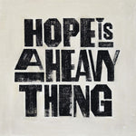 the album cover for Joy Oladokun - Hope Is A Heavy Thing [Indie Exclusive Eco-Friendly Gray Blend]