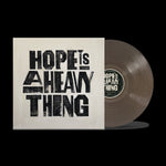 the album cover for Joy Oladokun - Hope Is A Heavy Thing [Transparent Black Ice]