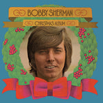 the album cover for Bobby Sherman - Bobby Sherman Christmas Album [Clear Vinyl] [Limited Edition] (Red)