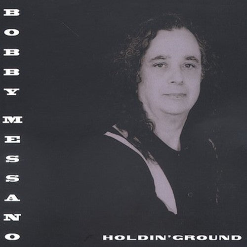 the album cover for Bobby Messano - Holdin' Ground