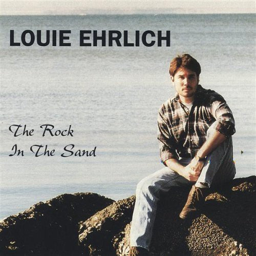 the album cover for Louie Ehrlich - The Rock in the Sand [Single]