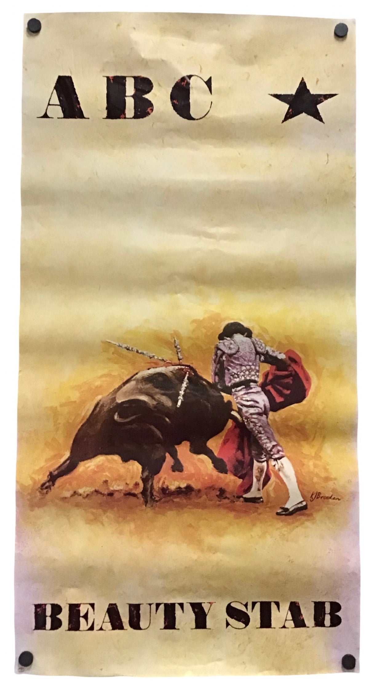A vertical banner or flag featuring a vintage-style bullfighting illustration with the text 'ABC' at the top and 'BEAUTY STAB' at the bottom. The design shows a matador with a red cape facing a bull, on a distressed beige and yellow background, with black metal grommets at the corners.