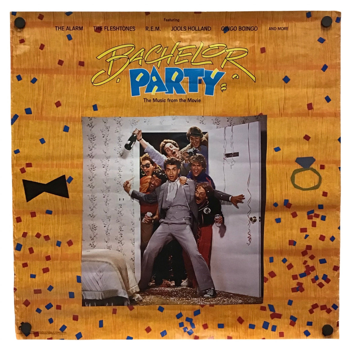 A square framed art print featuring a colorful graphic design inspired by the movie 'Bachelor Party'. The print has a light wood-grain textured border decorated with small red, blue, and black confetti, a black bow tie on the left, a ring on the right, and the title 'Bachelorette' in yellow and blue script at the top.