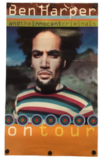 A vertical printed banner or flag featuring a portrait of Ben Harper with the text 'Ben Harper and the innocent criminals' and 'ontour', with an orange border and metal grommets at the bottom, shown against a plain white background.
