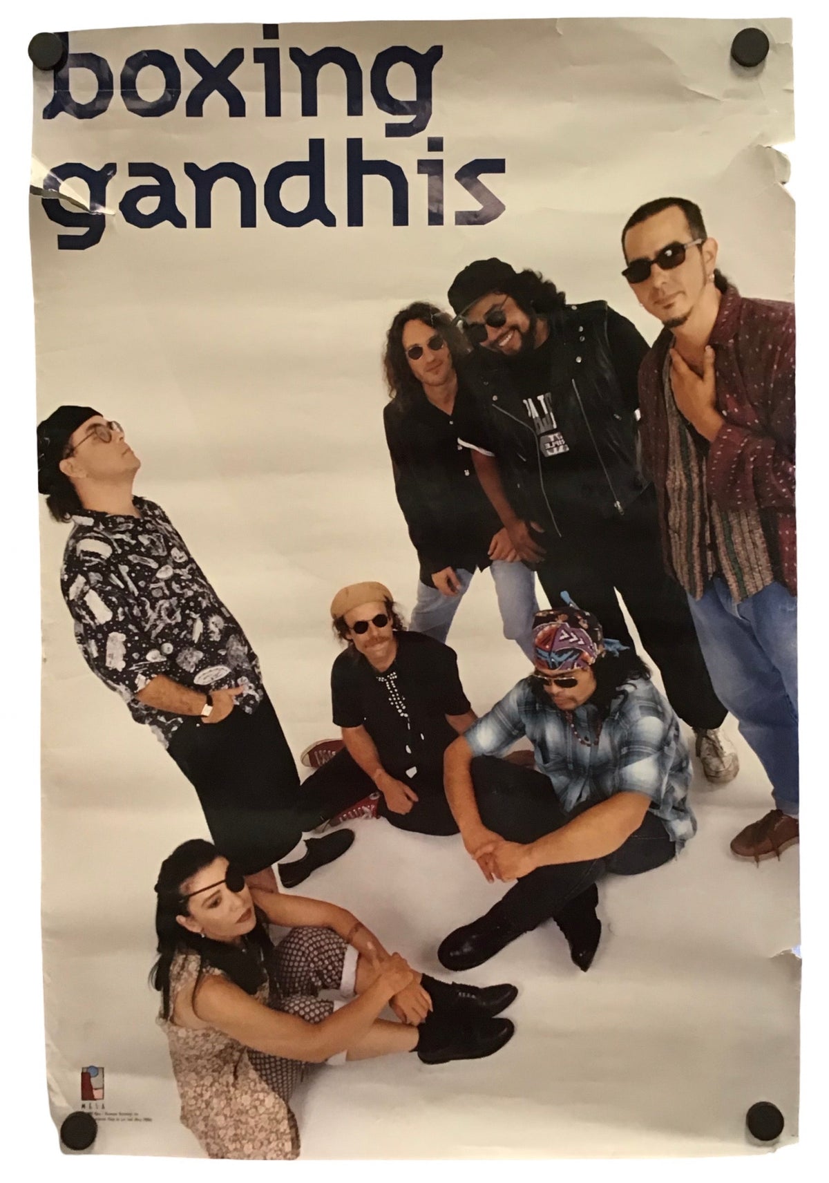 A vintage-style poster or print featuring the text 'boxing gandhis' at the top and a group photo of seven people dressed in black, displayed against a light gray background with visible mounting holes.