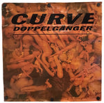 A square printed banner or sign with black metal grommets at the corners, featuring the text 'CURVE DOPPELGANGER' over a warm-toned photograph of many nude female bodies. The item is photographed against a plain white background.