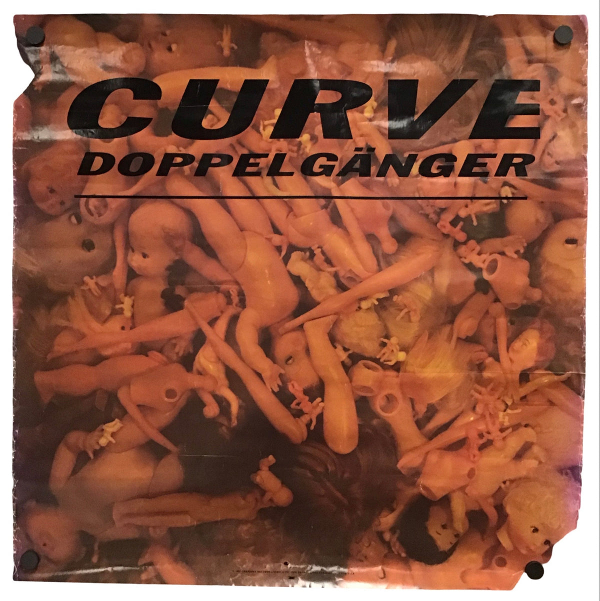 A rectangular printed sign or poster with the text 'CURVE DOPPELGÄNGER' in large black letters over a collage of nude human figures, shown against a plain white background.