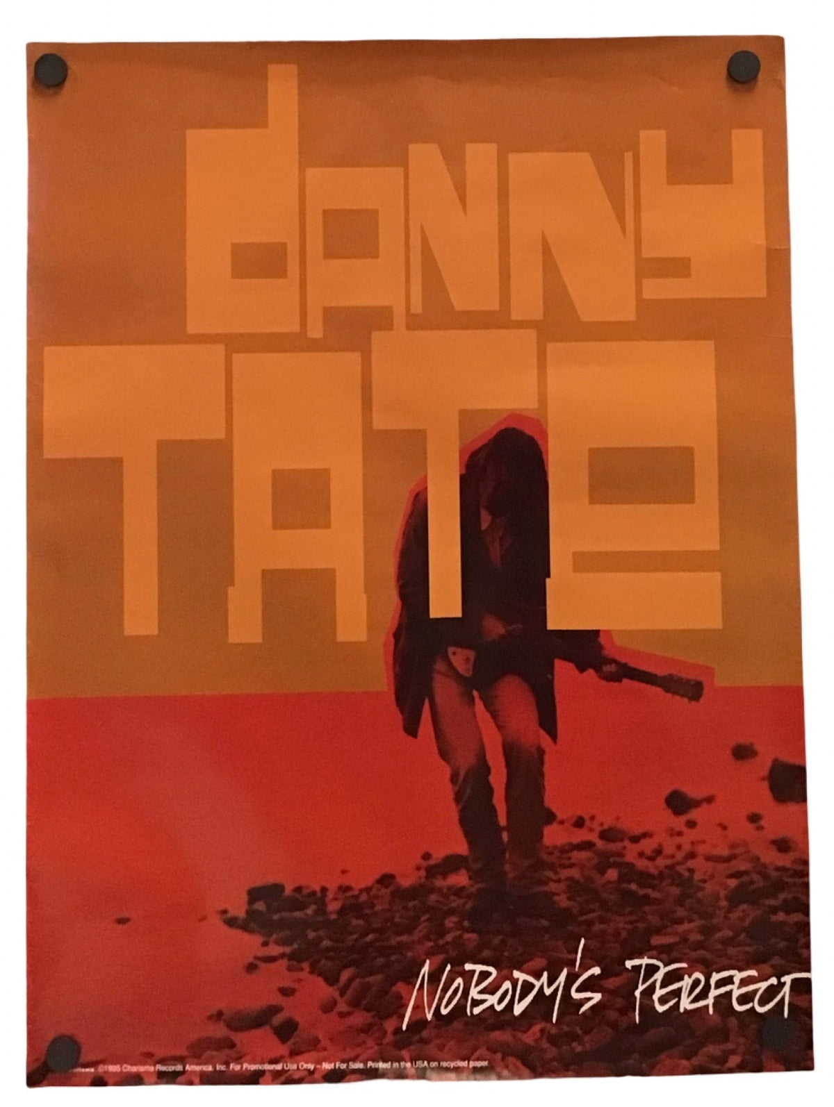 A vertical poster for the movie 'Danny Tate' featuring a stylized orange and red design with a silhouette of a person holding a rifle, mounted on a white background.