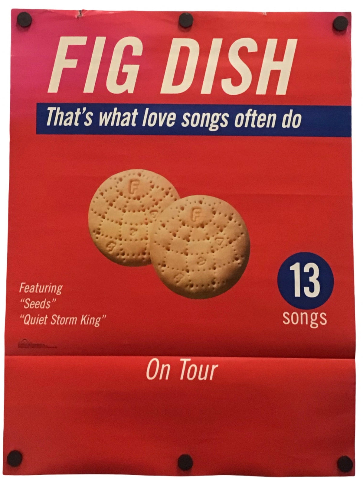 A red poster or album-style print for the band Fig Dish, with large cream text reading 'FIG DISH,' a blue banner reading 'That's what love songs often do,' two fig cookies pictured in the center, a blue circle saying '13 songs,' and 'On Tour' near the bottom.
