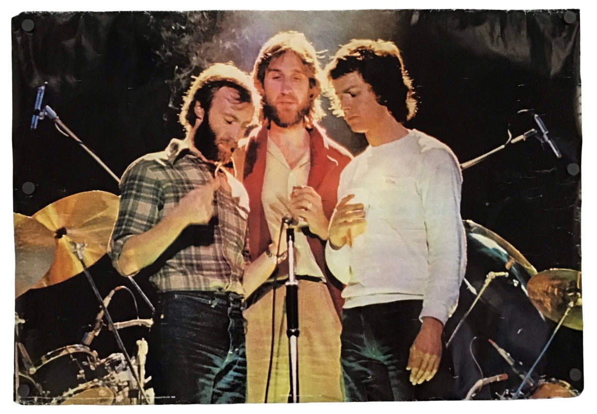 A rectangular canvas print featuring a vintage photograph of the band Genesis performing on stage, shown against a plain white background.