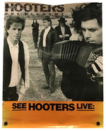 A vintage Hooters concert poster featuring a black-and-white band photo with a bright orange band at the bottom reading 'SEE HOOTERS LIVE'.