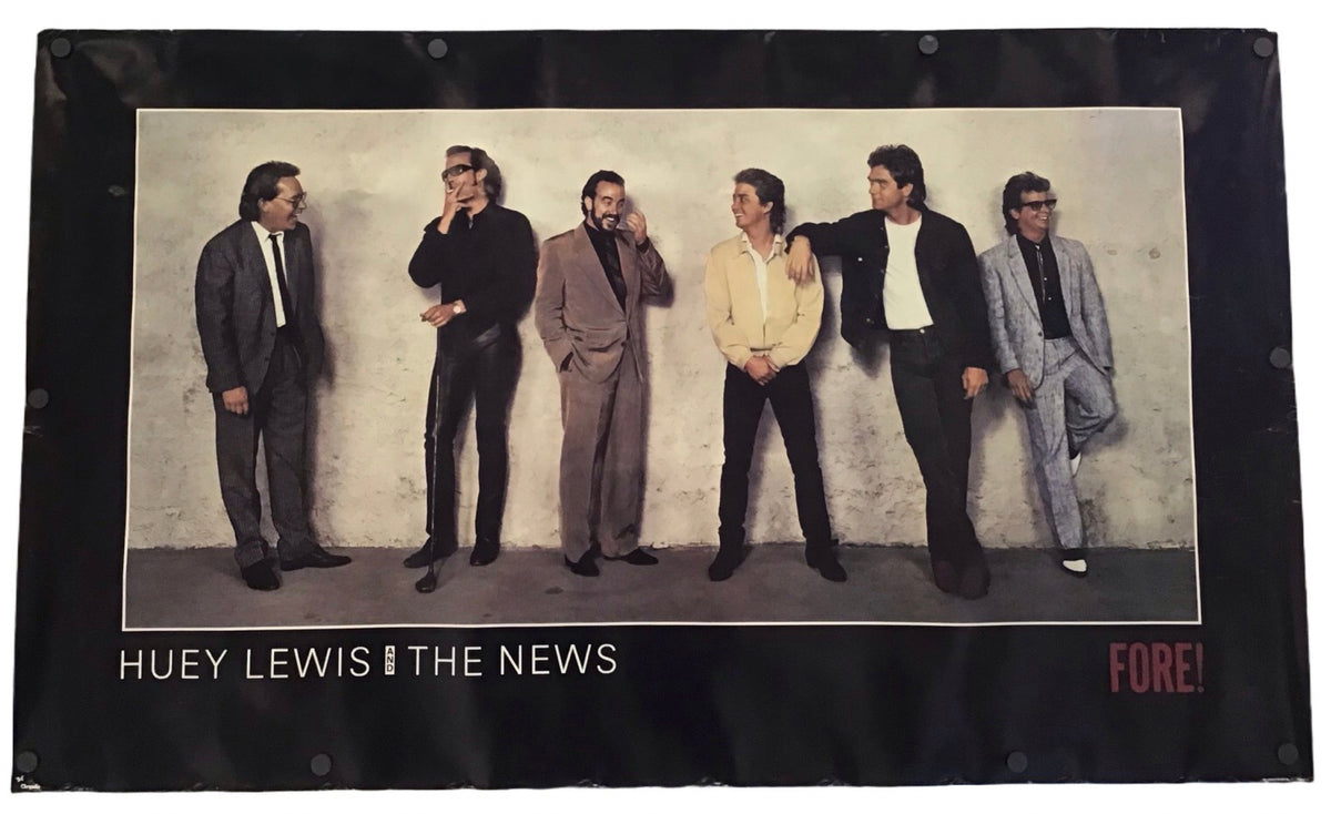 A vintage band poster for 'Huey Lewis & The News - Fore!' featuring a black border with a color photograph of the band members standing against a textured wall.