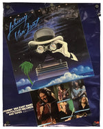 A vinyl poster for the Johnny Van Zant Band 'On Politics Records and Tapes' featuring a surreal graphic of a figure in a white suit and helmet under a starry night sky, with a small palm tree and a collage of band members at the bottom.