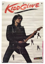 A vertical poster featuring a black-and-white photo of a rock guitarist wearing a black leather jacket and playing an electric guitar, with the red stylized text 'Kidd Glove' across the top. Small repeated silhouettes of guitarists appear along the right side, and a small 'Morocco' label is at the bottom right.