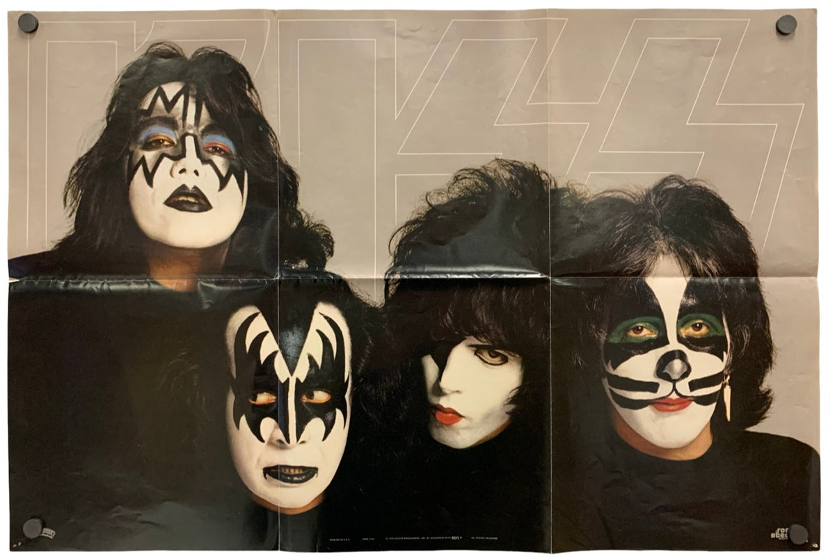 A vintage KISS band poster print featuring the four members in their signature makeup against a beige background with a faint large logo outline.