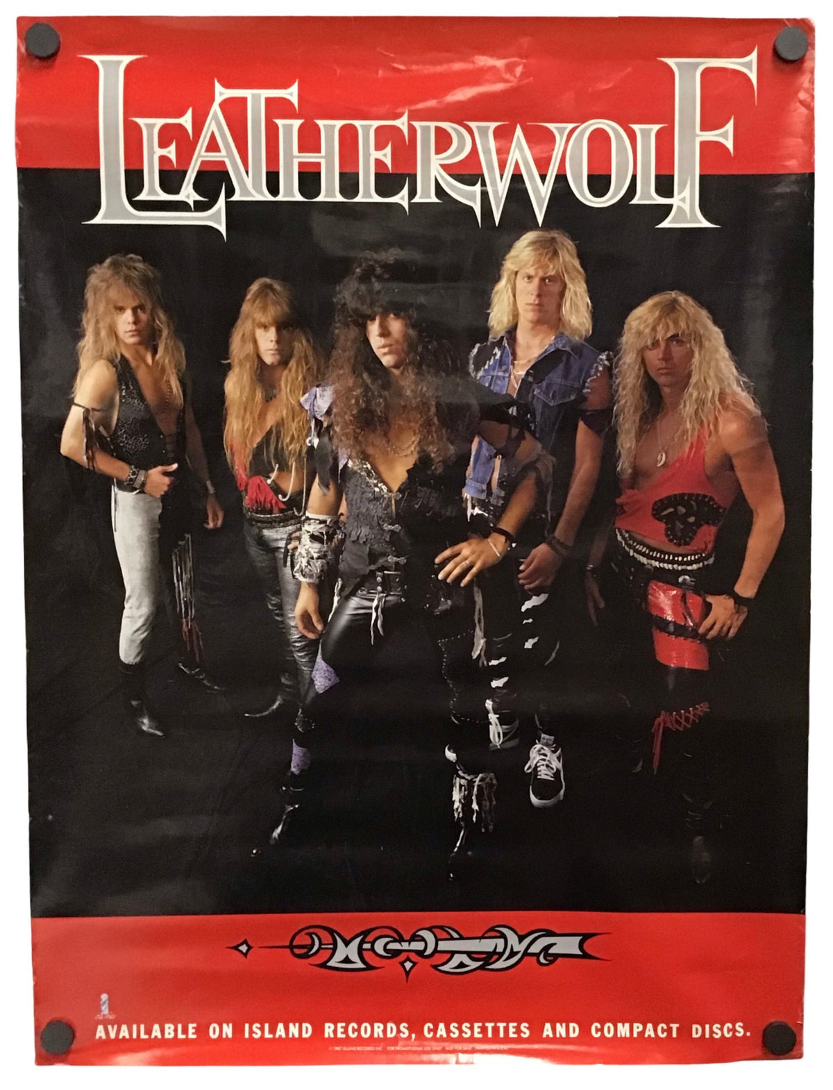 A vintage-style Leatherwolf band poster or print featuring five members against a black background with bold red borders at the top and bottom. The word 'LEATHERWOLF' appears prominently in white lettering, and smaller text at the bottom references Island Records, cassettes, and compact discs.