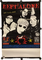 A vintage-style band poster for Left Alone hangs against a plain white background. The poster is black with red, white, and blue graphics, featuring the band members' portraits and text including 'LEFT ALONE' and 'Lonely Starts & Broken Hearts'.