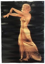 A vertical poster print featuring a stylized portrait of Marilyn Monroe in a shimmering gold dress against a dark black background, with visible mounting holes along the left and right edges.