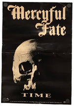 A black poster featuring a skull illustration with the text 'Mercyful Fate' at the top and 'TIME' at the bottom in a gold gothic font, shown against a plain white background.