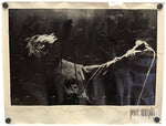 A black and white art print of Peter Murphy performing on stage, mounted on a cream-colored paper border with metal binder clips at the corners.
