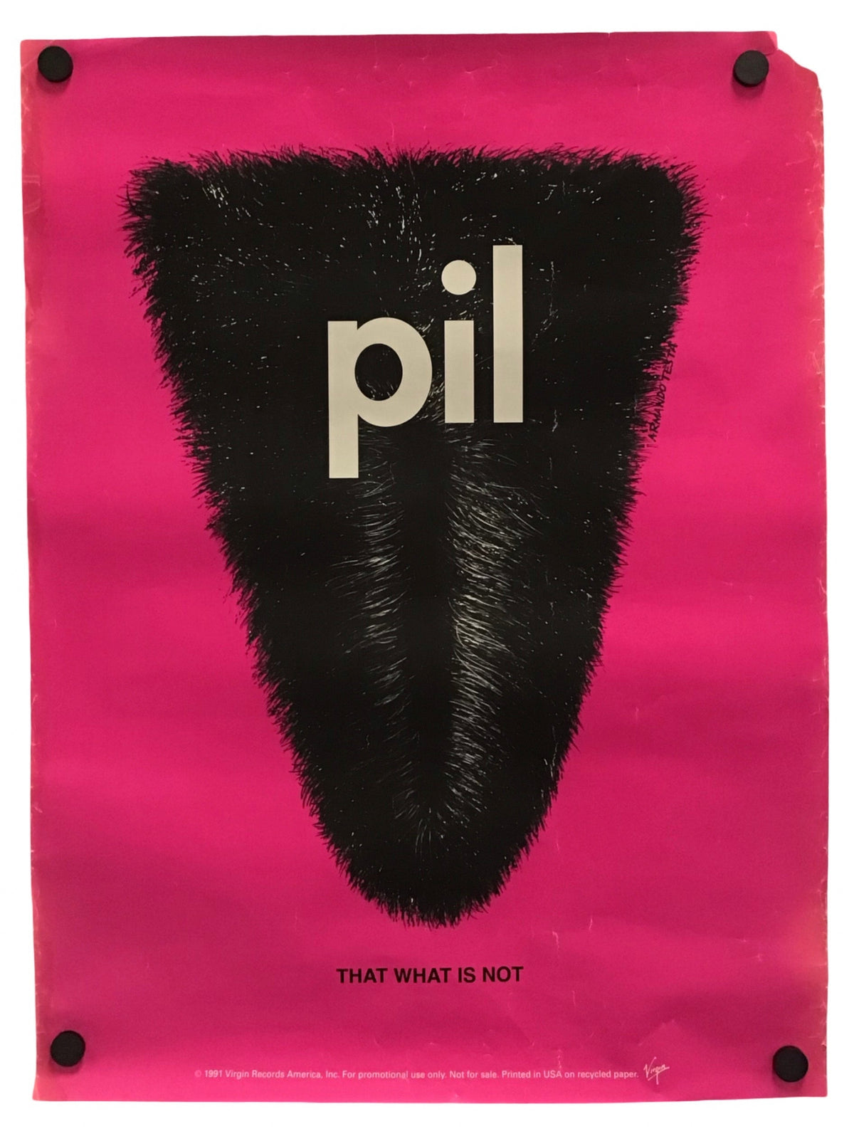 A poster print featuring a bright pink background with a large black fuzzy triangular shape in the center containing the word 'pil' in light beige. Small black pins are visible at the corners of the poster against a white background.