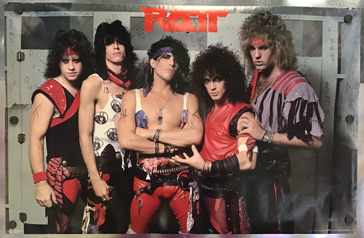 A square printed photo or poster of the rock band Ratt with five members posing in red, black, and white outfits, mounted or photographed against a metallic silver background.