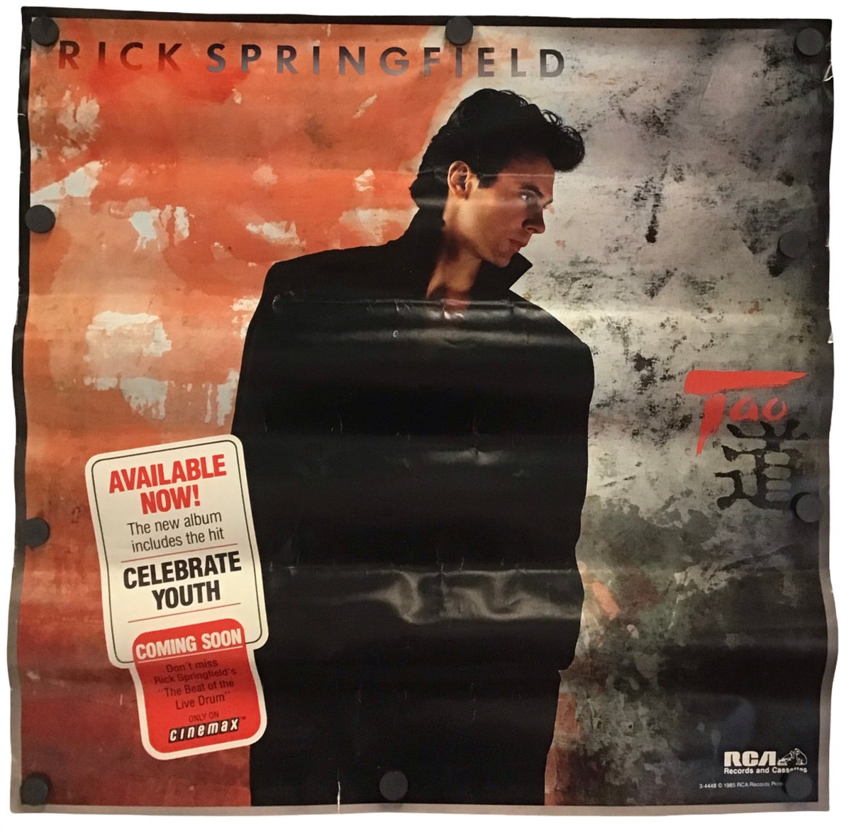 A vintage Rick Springfield poster, featuring a portrait of the artist against a split orange-red and gray textured background, with a red 'AVAILABLE NOW!' sticker on the lower left.