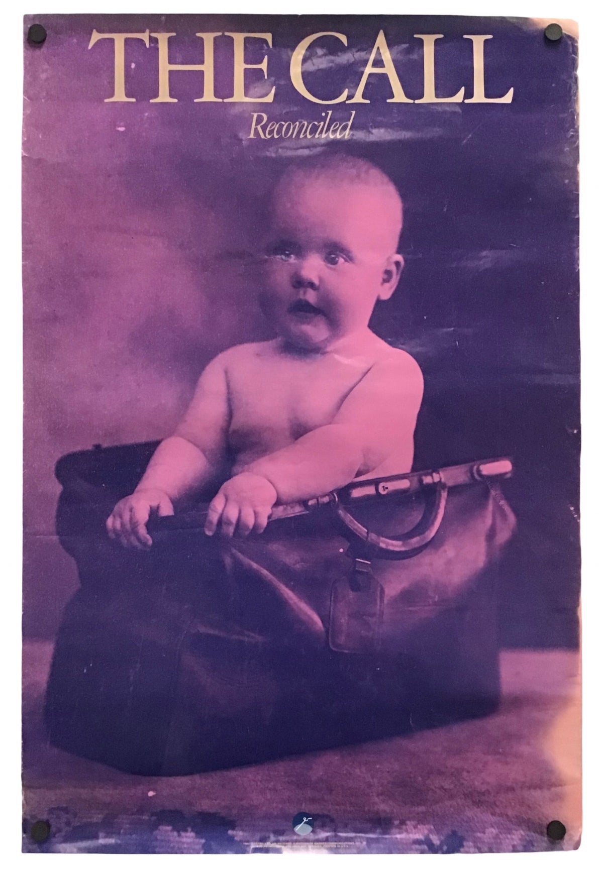 Vintage-style poster or print featuring a baby seated in a dark bag, with the text 'THE CALL Reconciled' at the top, shown against a plain white background.