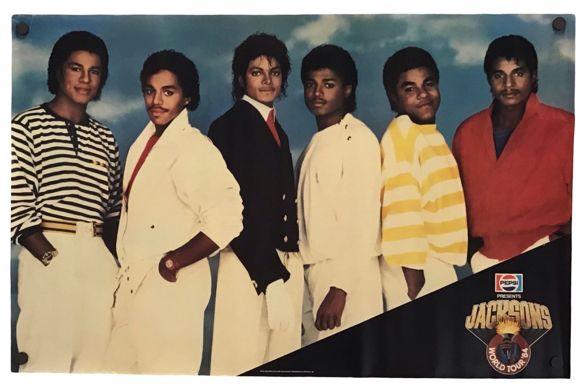 A vintage Jacksons group poster featuring the members in various outfits against a blue sky background, with a black diagonal banner at the bottom right displaying the Jackson 5 logo and a small NASCAR logo.