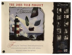The John Tesh Project 'Discovery' featured edition CD sleeve, showing the front cover artwork with a lighthouse illustration and the right side displaying tracklist and artist portraits on a white background.