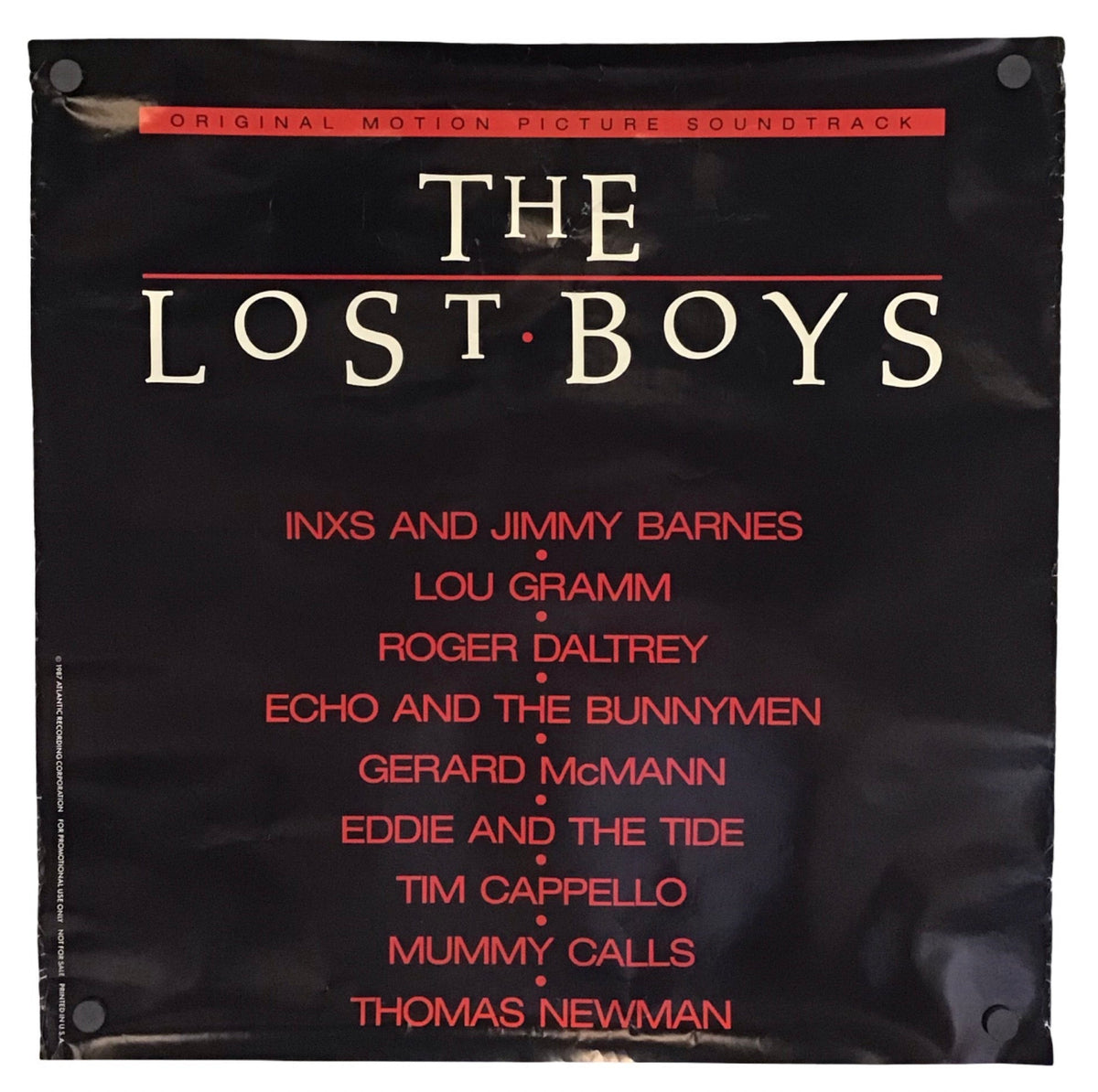 The Lost Boys original motion picture soundtrack album cover, featuring a black background with the title in large white letters and red text listing the cast names below.