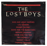 The Lost Boys original motion picture soundtrack album cover, featuring a black background with the title in large white letters and red text listing the cast names below.